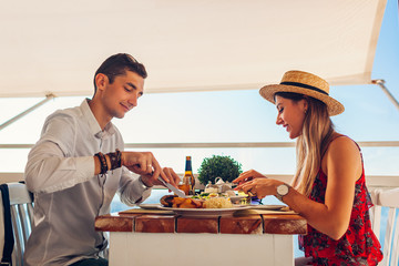 Romantic honeymoon dinner for two. Couple eating food and having drinks. Valentines day meal in cafe