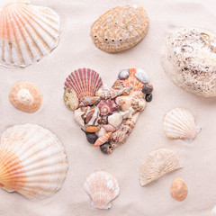 A heart made of small shells on the beach sand is love and St. Valentine's Day