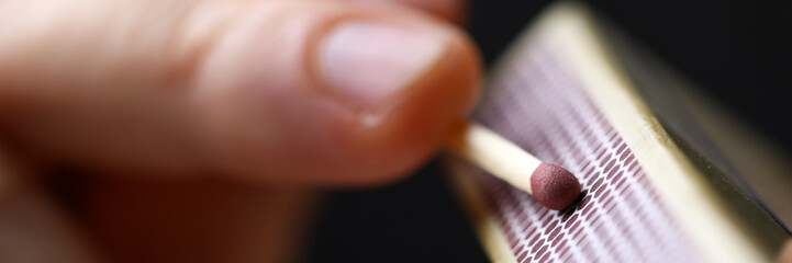 Male hands going to strat fire striking match