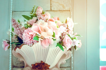 Many artificial pink and white roses are decorated on the wall to the backdrop in the wedding day. Beautiful flowers background, Selective focus.