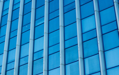 The building is made of glass. Glass facade of the building.