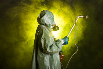 Radiation and danger concept - Man in the gas mask and chemical suit. The worker doing measure...