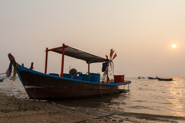 Naklejka na ściany i meble Bang Pra, Chonburi Thailand - January 18,2020 : Small Fishing boat stop at the beach in evening.