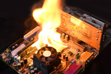 Fire Burning ,blazing computer motherboard, cpu,gpu and video card, processor on circuit board with...