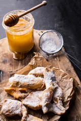 The faworki, angel wings - sweet, carnival pastries on a cutting board. Fat Thursday's traditional delicacy.