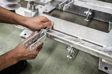 Close up shot of manual worker hands. Factory for industrial production of electric housings and surge arresters.