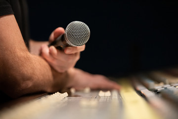 Close-up of classic microphone in hand of a music producer