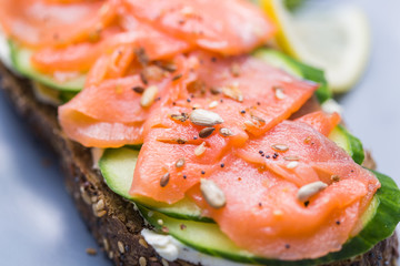 Sandwich with smoked salmon and cucumber. Concept for healthy nutrition.