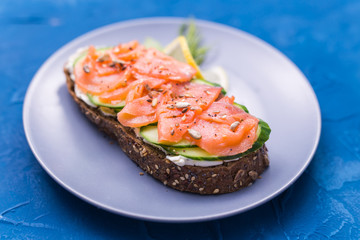 Sandwich with smoked salmon and cucumber. Concept for healthy nutrition.