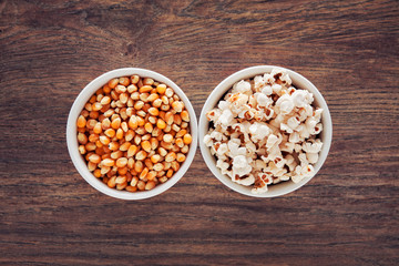 Two bowls filled with popcorn and corn maize or kernel seed