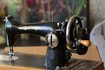 Machine pulley with wooden handle as part of the old manual sewing machine