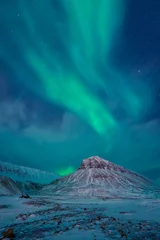 Fotobehang The polar arctic Northern lights aurora borealis sky star in Norway Svalbard in Longyearbyen  with the  mountains. Travel adventure © bublik_polina