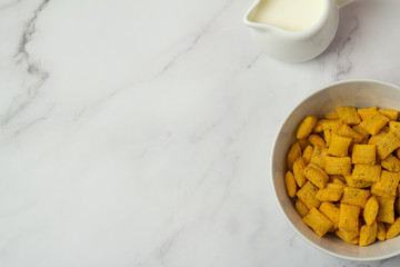 cornflakes in bowl on wooden table