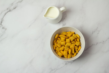 cereal, cup of black coffee and milk on a white background top view