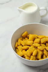 cornflakes in bowl on wooden table