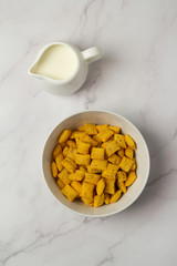 cereal, cup of black coffee and milk on a white background