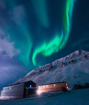The polar arctic Northern lights aurora borealis sky star in Norway Svalbard in Longyearbyen  with the  mountains. Travel adventure