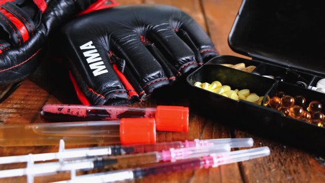 mma gloves with steroids composition on wooden background