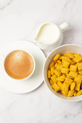 cereal, cup of black coffee and milk close-up