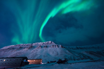 The polar arctic Northern lights aurora borealis sky star in Norway Svalbard in Longyearbyen  with the  mountains. Travel adventure