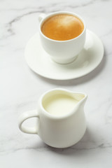 black coffee and milk on a white background