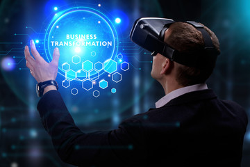 Business, Technology, Internet and network concept. Young businessman working on a virtual screen of the future and sees the inscription: Business transformation