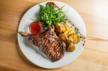 Juicy steak with vegetables , cooked on the grill.