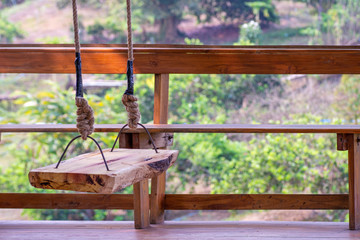 Wooden swings in the garden house