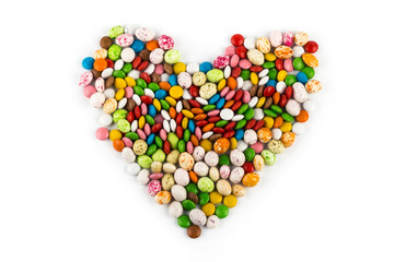 Easter holiday colorful heart of colorful round candies and candies similar to bird eggs