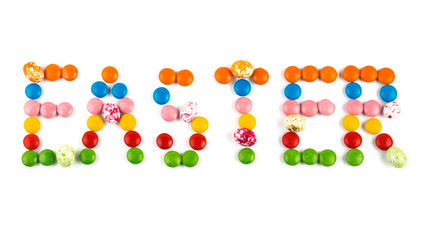 the word Easter is written with colorful bright round candies and candies that look like eggs