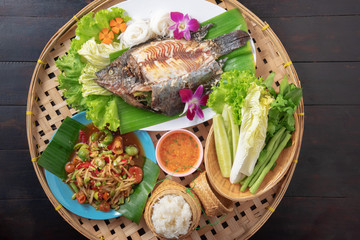 mixed thai isan food on black table