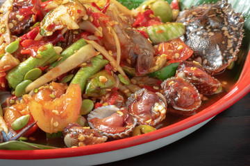 thai seafood salad mixed with Papaya, chopped on colorful tray