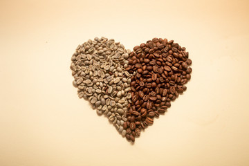 Heart made out of green and roasted coffee beans