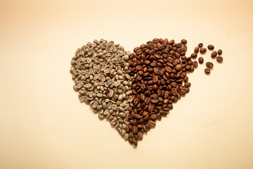 Heart made out of green and roasted coffee beans