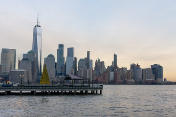 Fototapeta na wymiar Lower Manhattan New York City Skyline seen from Jersey City with a Christmas Tree during a Sunset