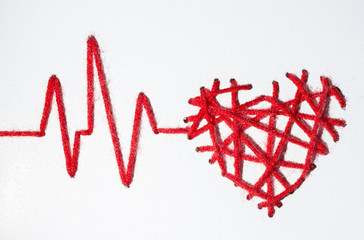 heart with pulse with drops made of red thread Valentine's Day love on a white background. copy...