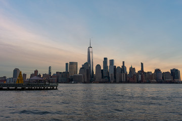 Fototapeta na wymiar Lower Manhattan New York City Skyline seen from Jersey City with a Christmas Tree during a Sunset