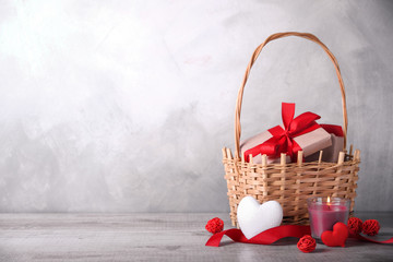 Greeting card Valentine's day with hearts ,goblet and gifts in basket on wooden background. With space for your text greetings © Ivan