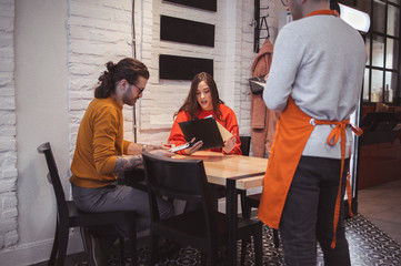 Waiter Takes Order From a young Couple