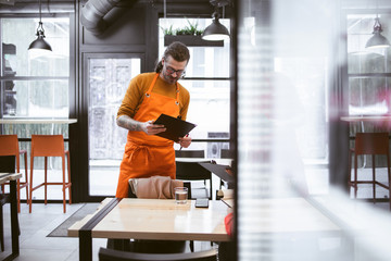 Fototapeta premium Young Waiter at Fast Food Restaurant