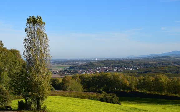 panoramic view across lush green meadows towards the rolling hills of the Black Forest, view from the Schutterlindenberg Lahr towards the village of Heiligenzell, Baden Germany