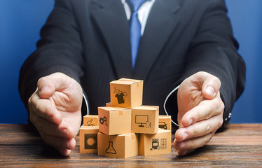 Businessman covers boxes goods. Business management. Commodity circulation import export. Marketing...