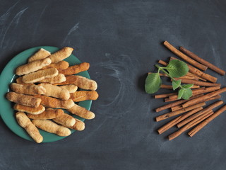 Homemade shortbread biscuits with cinnamon and nuts against a dark background. Home kitchen. We bake cookies.