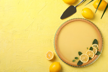 Composition with lemon tart on yellow background, top view