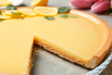 Composition with lemon tart on grey background, close up