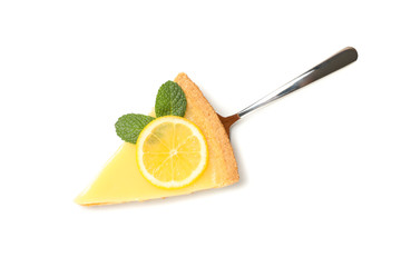 Spatula with lemon tart slice isolated on white background