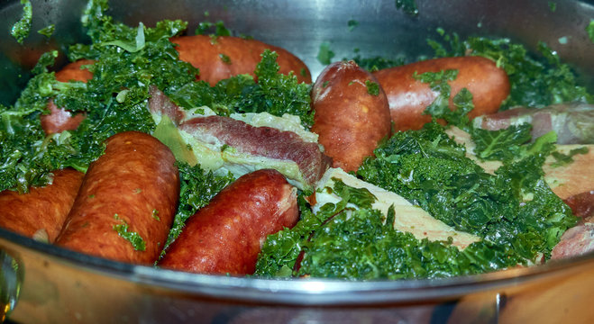 Kale with Bregenwurst sausage and smoked bacon, typical North German winter meal, home cooking, hearty