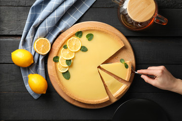 Composition with lemon tart on dark wooden background, top view