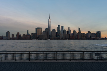 Fototapeta premium Lower Manhattan New York City Skyline seen from the Jersey City Waterfront during a Sunset