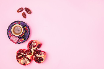 Background Flat Lay with Turkish Delight Turkish Coffee Date Fruit and Garnet on Pink Background Top View Copy Space Ramadan